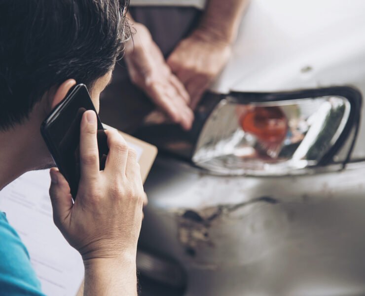 Insurance agent working during on site car accident claim process - people and car insurance claim concept